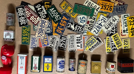 Two boxes of misc auto related collectibles - banks, decals, miniature license plates, key cases,