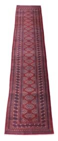RUG: Modern Bokhara runner, 12' 7" l. x 2' 11" w., overall red with blue, cream and brown patterns