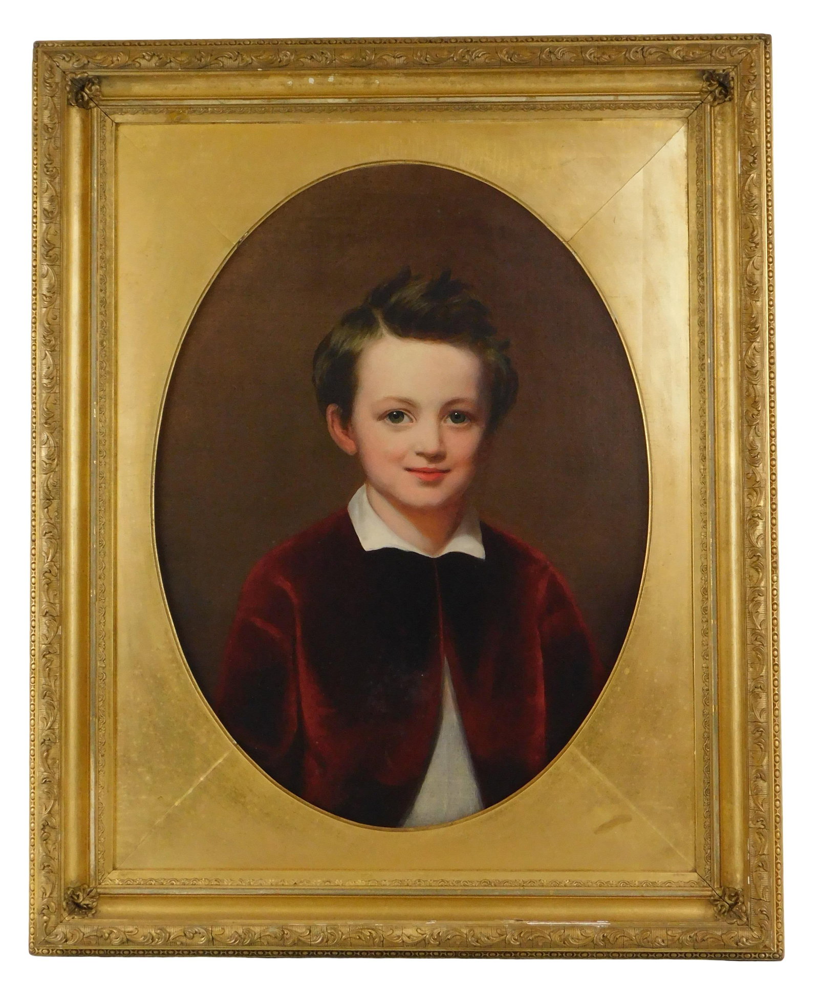 Early 20th C. portrait of young boy, oil on canvas laid down, the boy wears a burgundy velvet: Early 20th C. portrait of young boy, oil on canvas laid down, the boy wears a burgundy velvet overcoat with a white collared shirt, he has a slight calm smile with a glimmer in his eye, no signature v