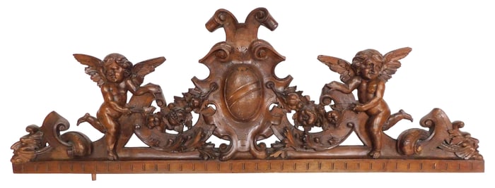 Renaissance Revival carved architectural pediment with winged putti flanking heraldic shield, nicely