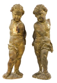Two Continental carved wood putti, 18th C. or later, newer paint over original gilded on plaster,