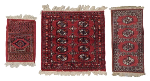 RUG: Three modern Bokhara, all red with accents of cream, black, brown and orange, smallest: 16" x