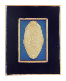 Framed carved bone-type plaque, 19th C., design features four putti with florals and garland, traces