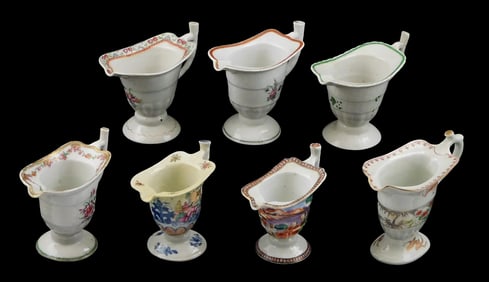 ASIAN: Seven Chinese Export porcelain helmet pitchers, c.1785-1825, with various famille rose and