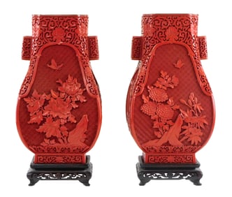 ASIAN: Pair of Chinese cinnabar carved lacquered vases, 20th C., each with flanking handles, carved