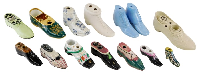 Fourteen porcelain shoe writing accessories, four inkwells and nine pen holders, most unmarked, two