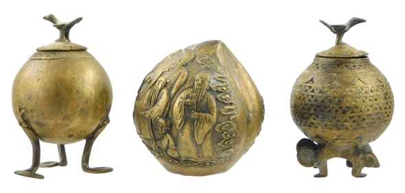 ASIAN: Three Eastern brass spheres: one Chinese type peach-form shaker featuring raised decoration