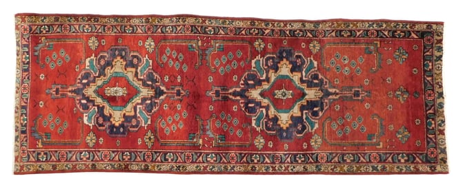 RUG: Antique Persian Heriz carpet, wool on cotton, c. 1950's, red ground, accents of blue and green,