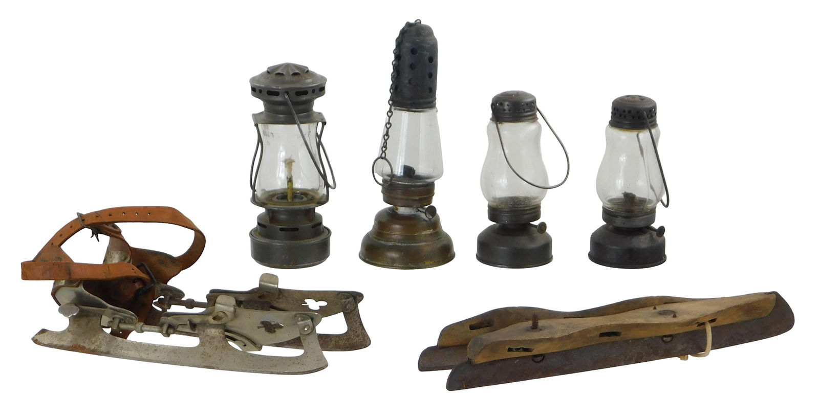 Late 19th- early 20th C. ice skating accessories, details include: four early ice skating lanterns, : Late 19th- early 20th C. ice skating accessories, details include: four early ice skating lanterns, one hood labelled Dietz Sport, Made in USA, patented July- 26- 04, [etc.]", one with hanging chain,