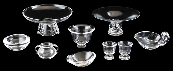 Nine pieces of Steuben glass, details include: two larger compotes, one with stepped foot, one with
