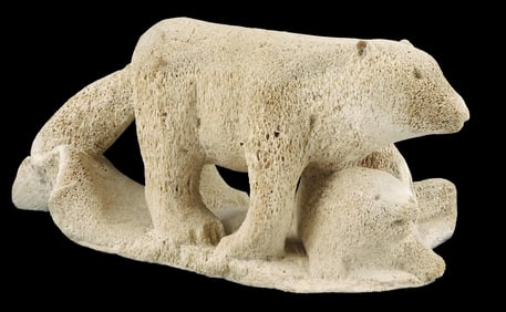 Inuit petrified whale bone carving of animal, cream colored highly porous material depicts a