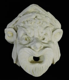 GARDEN: High relief sculptural masque, grotesque stone face with open mouth and grimacing