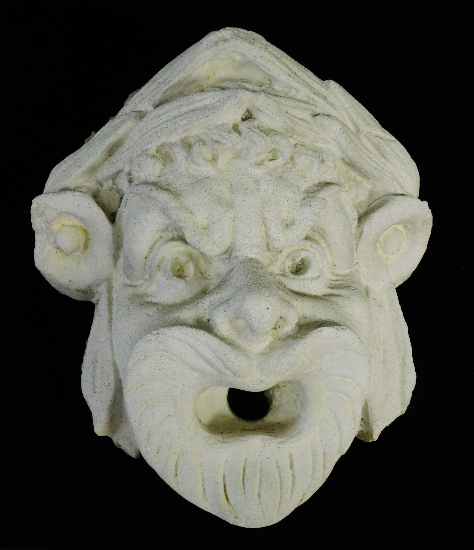 GARDEN: High relief sculptural masque, grotesque stone face with open mouth and grimacing (1 of 3)