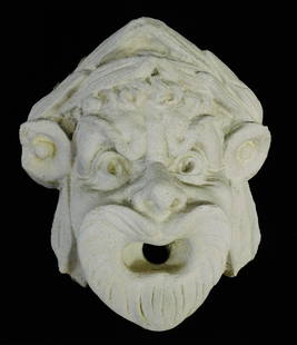 GARDEN: High relief sculptural masque, grotesque stone face with open mouth and grimacing: GARDEN: High relief sculptural masque, grotesque stone face with open mouth and grimacing expression, light grey stone possibly previously part of fountain, wear consistent with age and outside use, s
