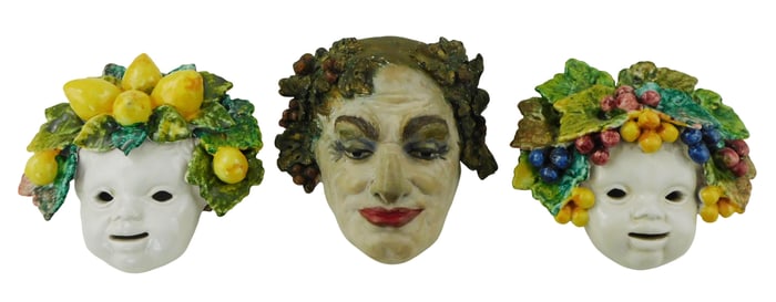Three Continental pottery masks, details include: two Bacchus child masks with mixed fruit, Italian,