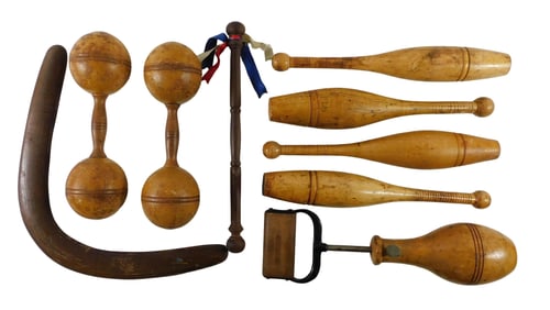 Nine pieces of early wooden exercise and sporting equipment, including: four Indian Clubs, one pair