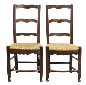 Pair of French ladderback side chairs, 18th-19th C., each with shaped slats over rush seat, bowed