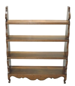Walnut standing bookshelf, 20th C., natural finish, four shelves with molded fronts, shaped sides,