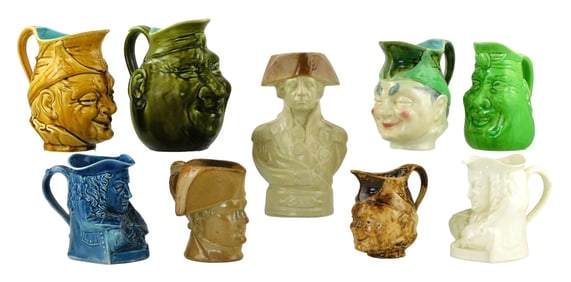 Wedgewood, Sarreguemines, etc., nine character pitchers in face and figural forms, late 19th/early