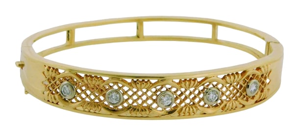 JEWELRY: 14K diamond bangle bracelet, hinged with safety chain, tested 14K yellow gold, five round