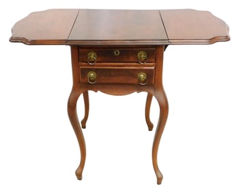 Two-drawer stand, European, 19th C., walnut with shaped drop leaves supported by knuckle hinged