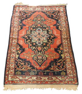 RUG: Antique Persian tribal Heriz style rug, 6' 6" x 4' 5", wool on cotton, central medallion on a: RUG: Antique Persian tribal Heriz style rug, 6' 6" x 4' 5", wool on cotton, central medallion on a red field, cream primary border, wear consistent with age and use including worn areas, unraveled end