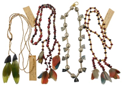 Four necklaces including three Brazilian tribal bead and parrot feather necklaces, all with Artindia