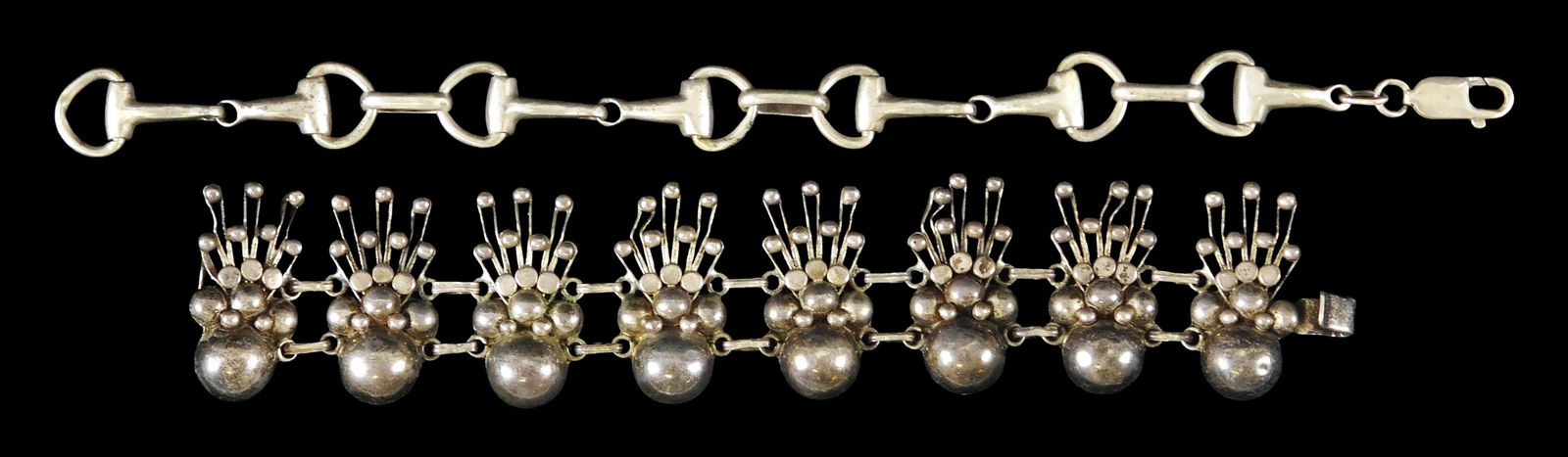 STERLING: Two Mexican sterling link bracelets: first a Taxco bracelet with floral design, no maker's: STERLING: Two Mexican sterling link bracelets: first a Taxco bracelet with floral design, no maker's mark viewed by likely Talleres De Los Ballesteros, stamped "TAXCO 980" on hook, some bends to drops