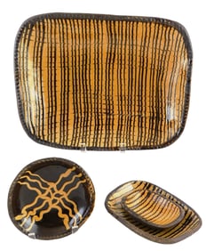Colonial Williamsburg slip glazed pottery, four pieces including oblong platter and three dishes,