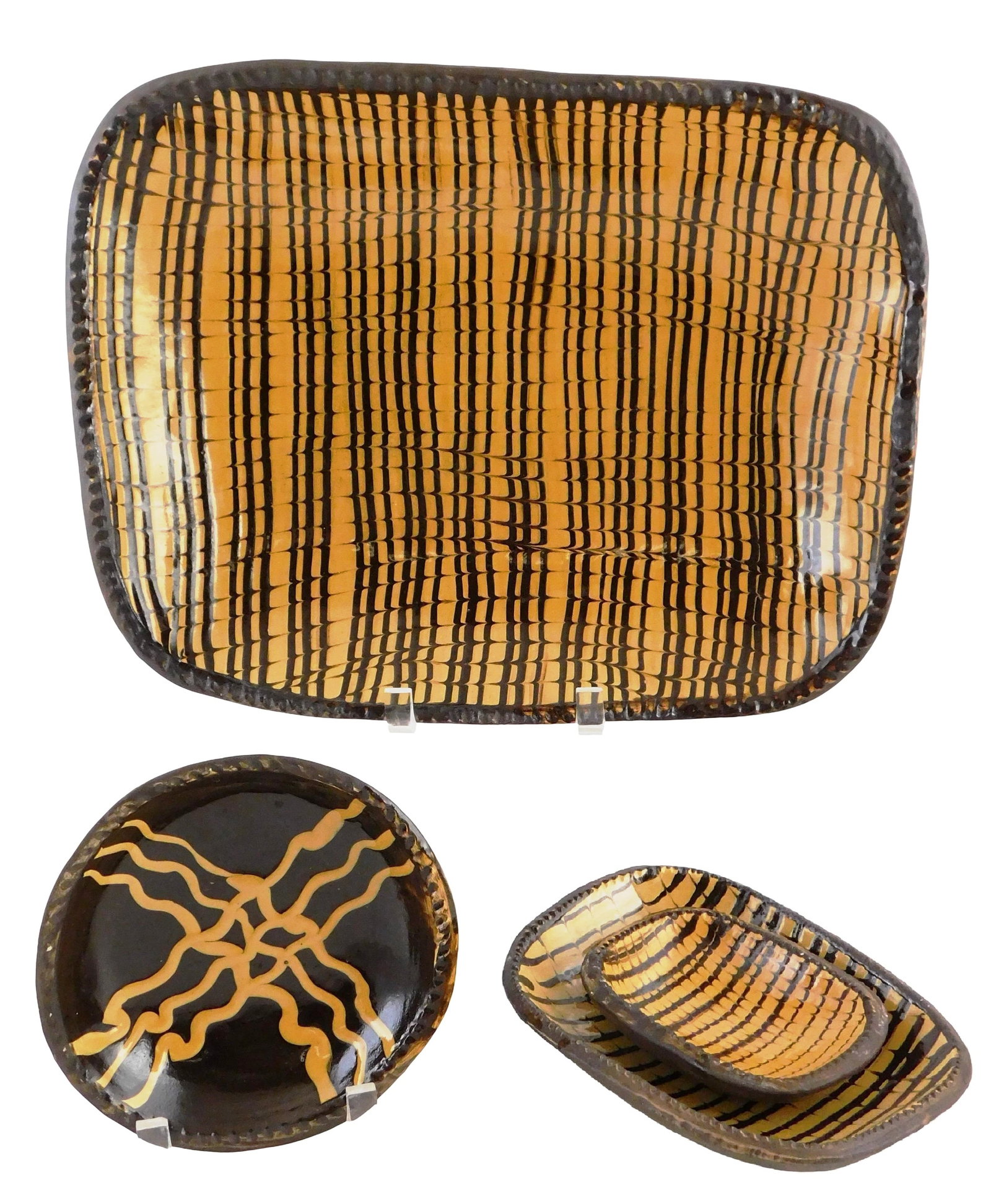 Colonial Williamsburg slip glazed pottery, four pieces including oblong platter and three dishes, (1 of 5)