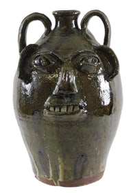 FACE JUG: Burlon Craig (Vale, N.C.,1914–2002) large folk art pottery jug, mottled olive green