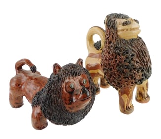 FOLK ART POTTERY: Two primitive redware lion figures, one by Billy Ray Hussey and one by Peggy