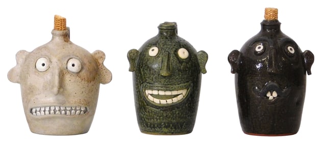 FACE JUGS: Three Sid Luck (Seagrove, N.C., 20th/ 21st C.) folk art pottery face jugs, all signed on