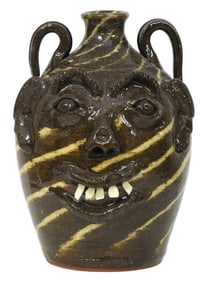 FACE JUG: Walter Fleming (North Carolina, b. 1937), double-faced folk art pottery jug, glazed