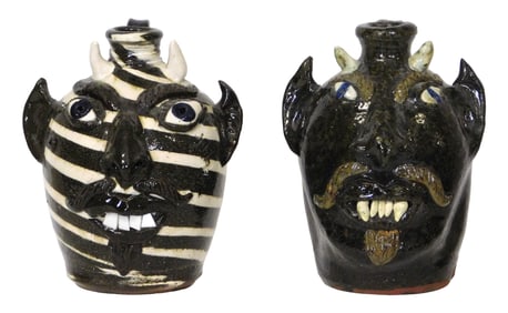 FACE JUGS: Two Albert Hodge (Vale, N.C., b. 1941) folk art pottery grotesque face jugs, both devil
