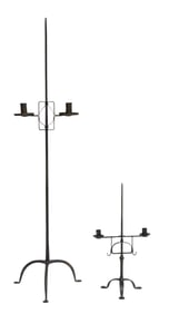 Two tripod base iron candleholders, including: one tall, floor candlestand, adjustable holder with