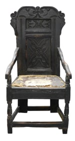 English armchair 17th C., oak, carved crest and back panel, curved and sloping arms supported by