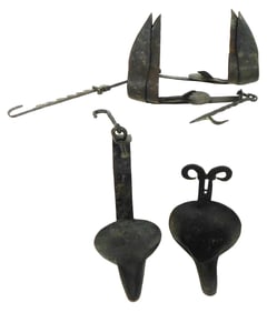 Three betty lamps, iron, each with double reservoirs and hooks, details include: one with sawtooth
