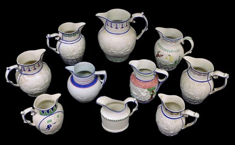 Castleford-type pitchers, ten total, all with blue trim and polychrome details, all with varying