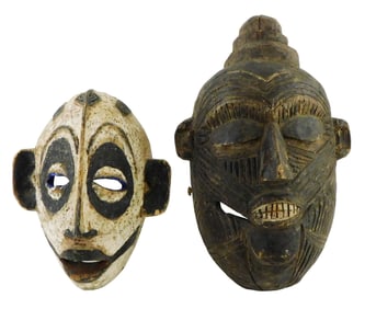 TRIBAL: Two carved wooden masks, 19th/20th C., including: Ibo/Igbo Nigerian mask, painted black &