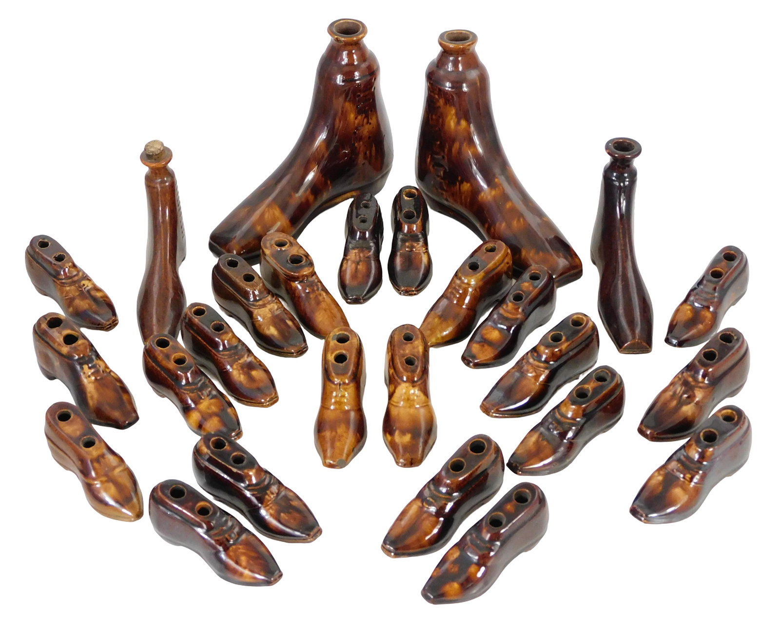 Bennington/Rockingham shoe-form wares, twenty-six pieces total, unmarked, twenty-two pen holders &: Bennington/Rockingham shoe-form wares, twenty-six pieces total, unmarked, twenty-two pen holders & four flasks, some pairs including flasks, labels on largest pair indicating “Rockingham”