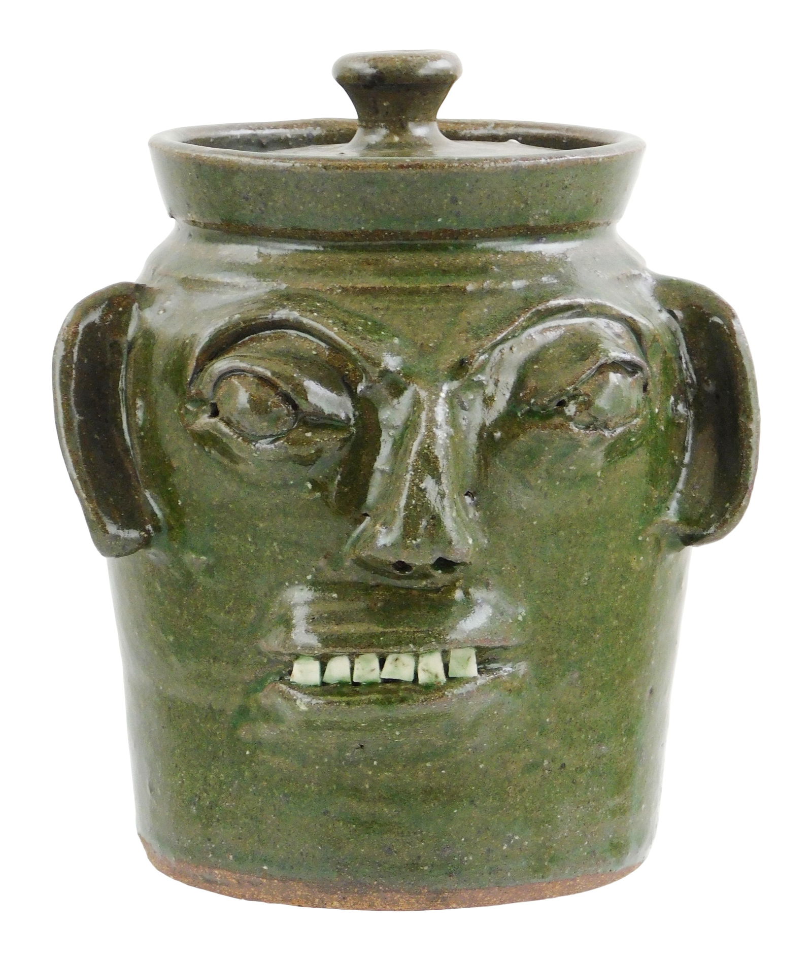 +FOLK ART POTTERY: Burlon Craig (Vale, N.C.,1914–2002) pottery jar with primitive/ grotesque face: +FOLK ART POTTERY: Burlon Craig (Vale, N.C.,1914–2002) pottery jar with primitive/ grotesque face decoration, maker's mark stamped on base "B. B. CRAIG, VALE N.C.", earth-toned green glaze, removabl