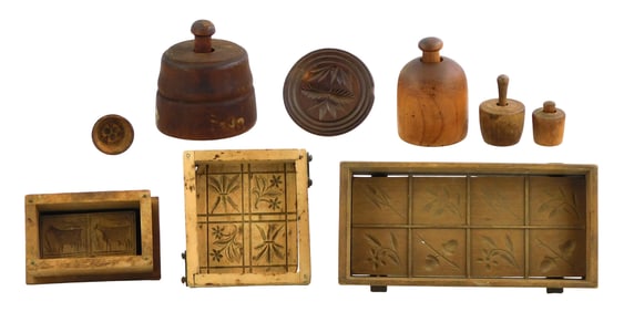 Nine treenware butter molds and stamps: including four butter stamps in circular form molds, three