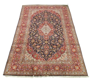 RUG: Kashan, 12' 10" x 8' 9", wool on cotton, central medallion on red field, dark blue major border