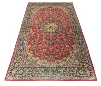 RUG: Isfahan carpet, 15' 3" x 9' 9", wool on cotton, navy blue border with central medallion on red