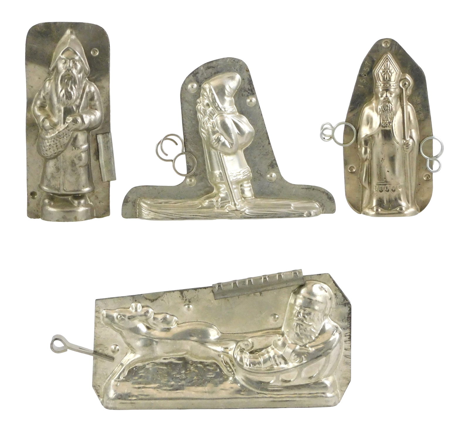 CHOCOLATE MOLDS: Four Christmas themed molds, including: German "Santa on Skiis", stamped "H. Walt, (1 of 2)