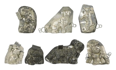 CHOCOLATE MOLDS: Seven dog-themed molds, including: "Poodle in Newspaper Hat" by Anton Reiche, c.