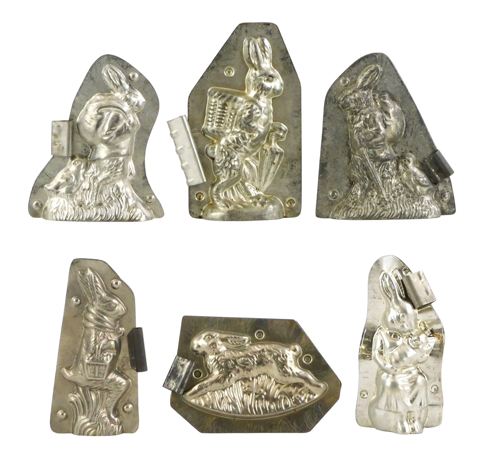CHOCOLATE MOLDS: Anton Reiche, Whygandt, etc., six Easter/ rabbit themed molds, including: walking: CHOCOLATE MOLDS: Anton Reiche, Whygandt, etc., six Easter/ rabbit themed molds, including: walking rabbit with sack followed by chick by Whygandt, Germany, no. 16521, 5" h.; near identical mold of wal