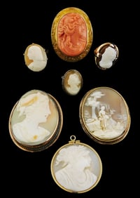CAMEOS: Seven items in stamped or tested 14k frames, including three brooches, one in coral type;