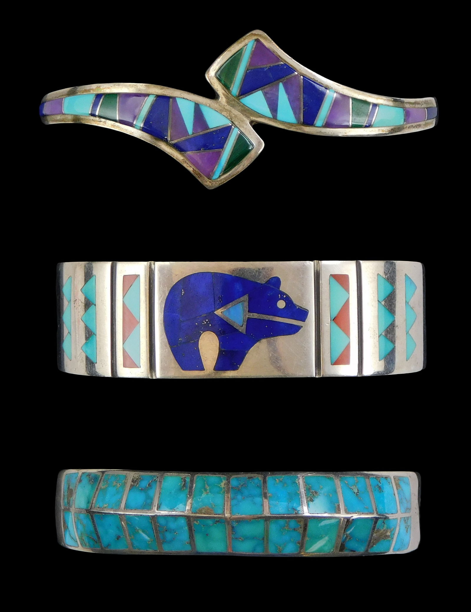 JEWELRY: Three Southwest silver cuff bracelets, all with Zuni style inlay, one featuring a spirit (1 of 2)